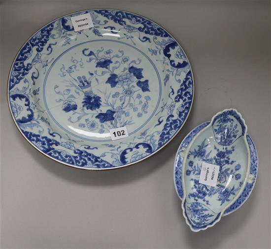 An 18th century Chinese blue and white dish and a double lipped sauceboat, dish diameter 35cm (both a.f.)
